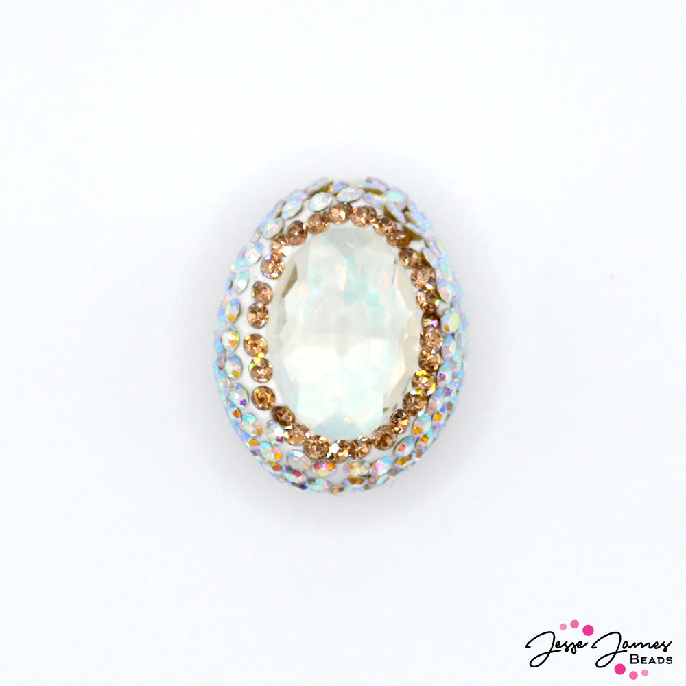 Add a pop of sparkle to your next piece with this rhinestone incrusted crystal focal bead. Each bead features an opaque AB Crystal center surrounded by mini AB rhinestones. Each bead in sold individually. Measures 22mm X 17mm 15mm.