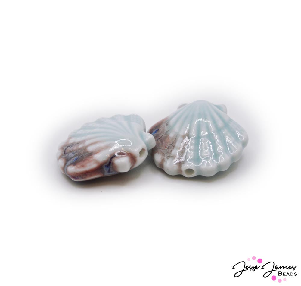 These light ceramic beads are the perfect focal for beach inspired jewelry creation. Each shell shaped ceramic bead measures 31mm x 29mm. Sold in pairs.
