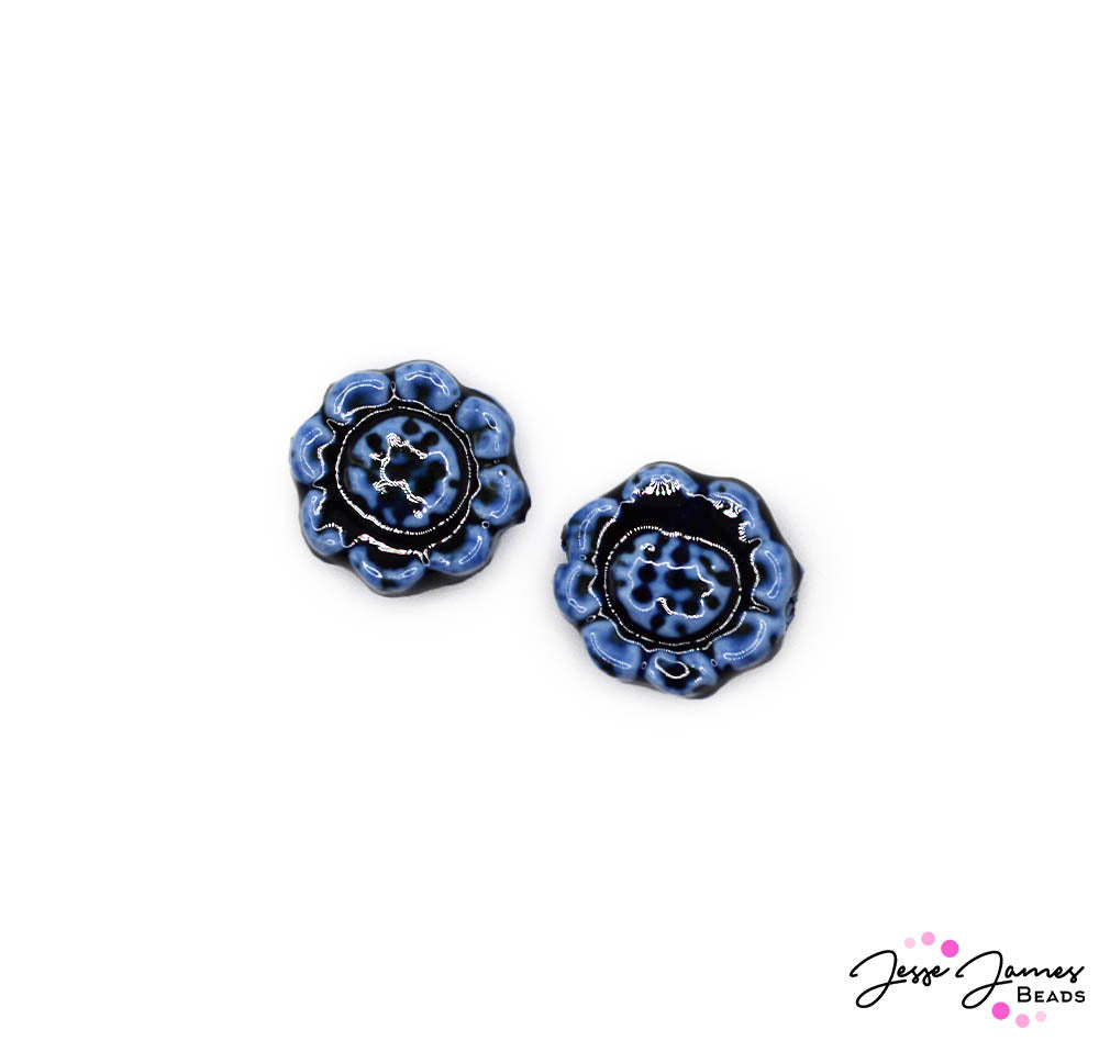 These ceramic beads feature a flower shape and rich hues of oceanic blue. Each bead measures 18mm and is sold in pairs.
