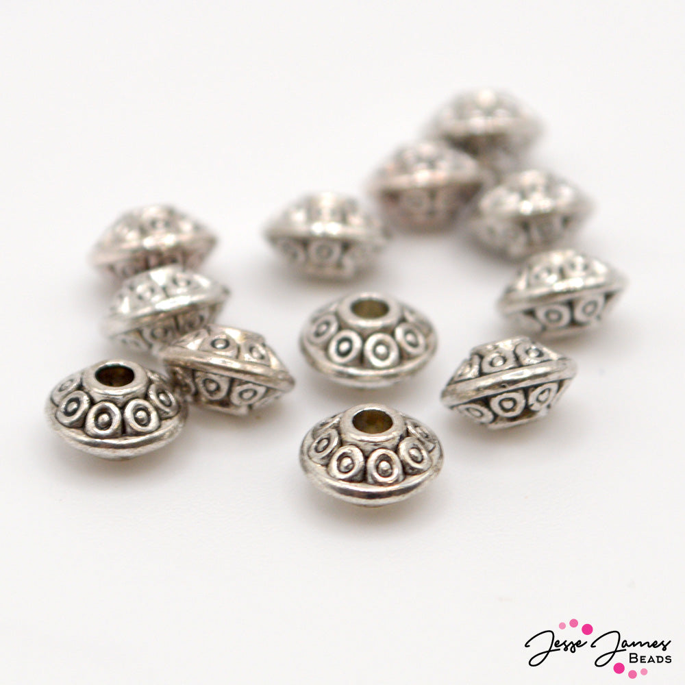 These adorable UFO shaped spacers will help you create out of this world jewelry. These spacers feature an antique silver color. Each spacer measures 4mm x 6mm. Spacers come in a set of 12.