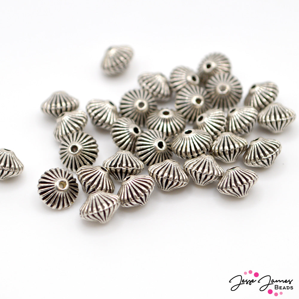 These bold disk-shaped spacers feature an antique silver color and intense line texture. Perfect for giving your jewelry a pop of interest! Each spacer measures 5mm x 7mm. Each set includes 30 pieces.