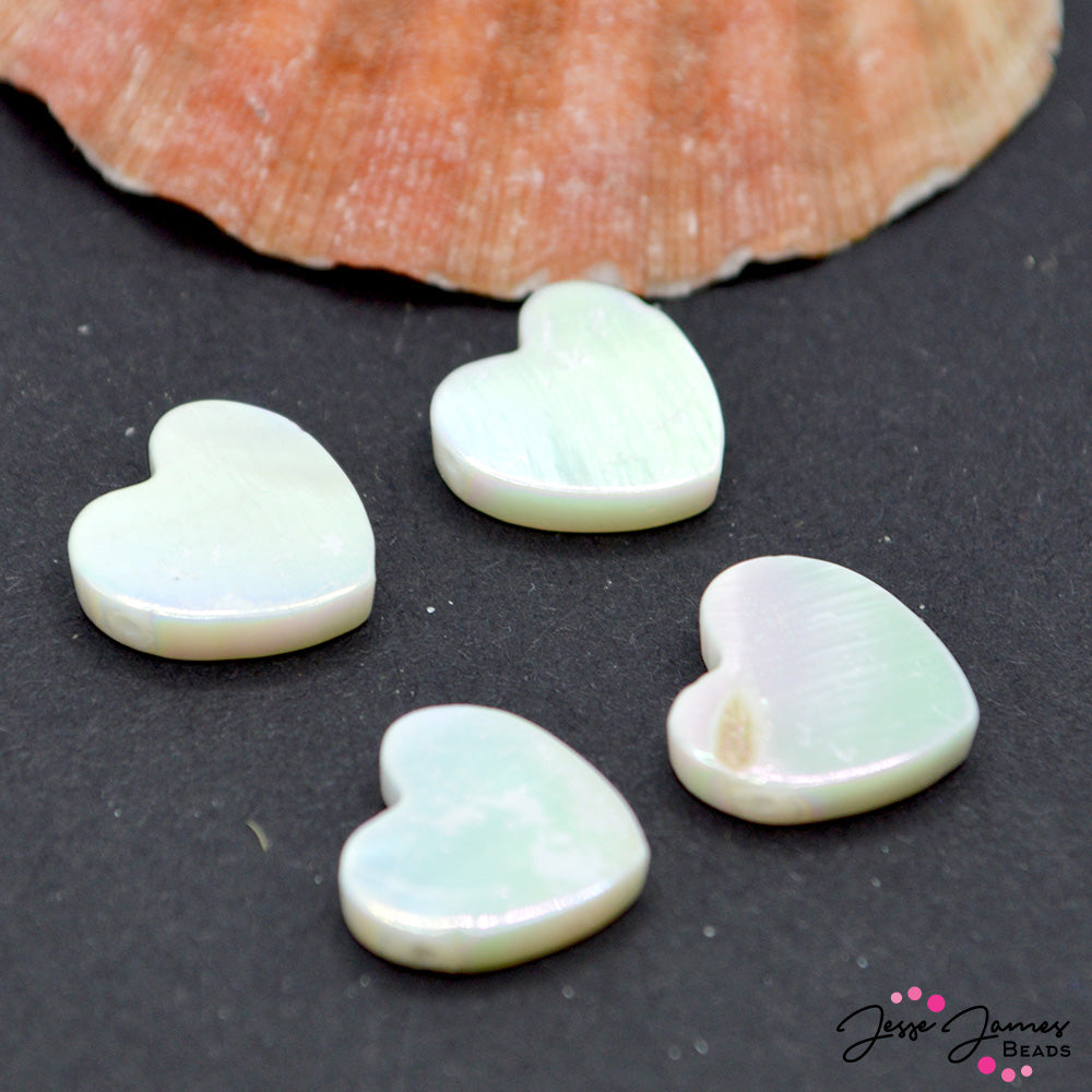 Add oceanic inspiration to your next jewelry creation with these shell sea-shanty worthy heart beads. These white mini hearts feature the natural grain of a seashell, meaning each heart has it's own unique personality and texture. Beads come in a set of 4. Measure 11mm X 10mm X 3mm.