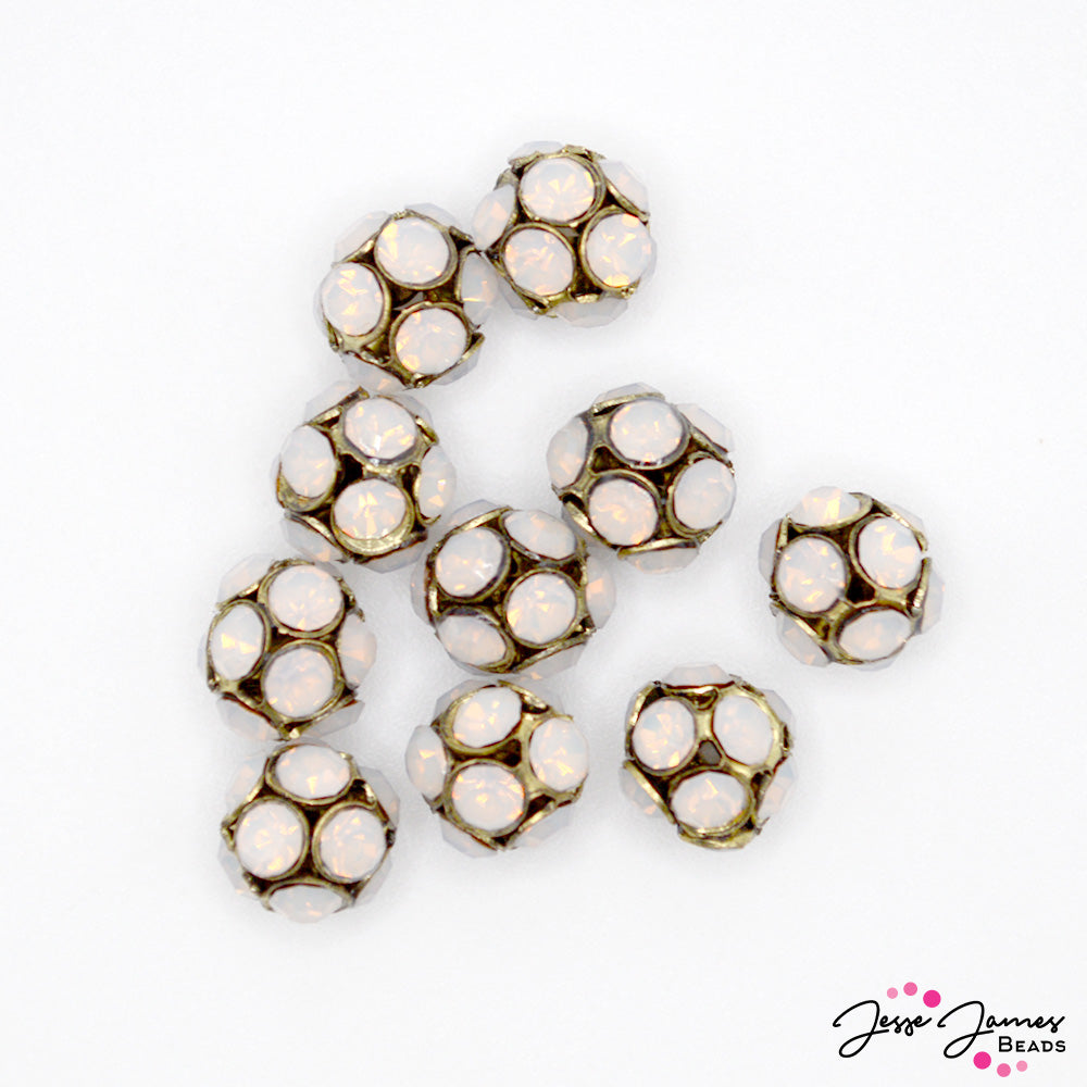 Create a bloom of spotted jellyfish with these mini metal and glass beads. Each set includes 10 antique gold metal beads decorated with glass rhinestones. These adorable accents pair will with white or crystal hues. Each bead measures 8mm. 