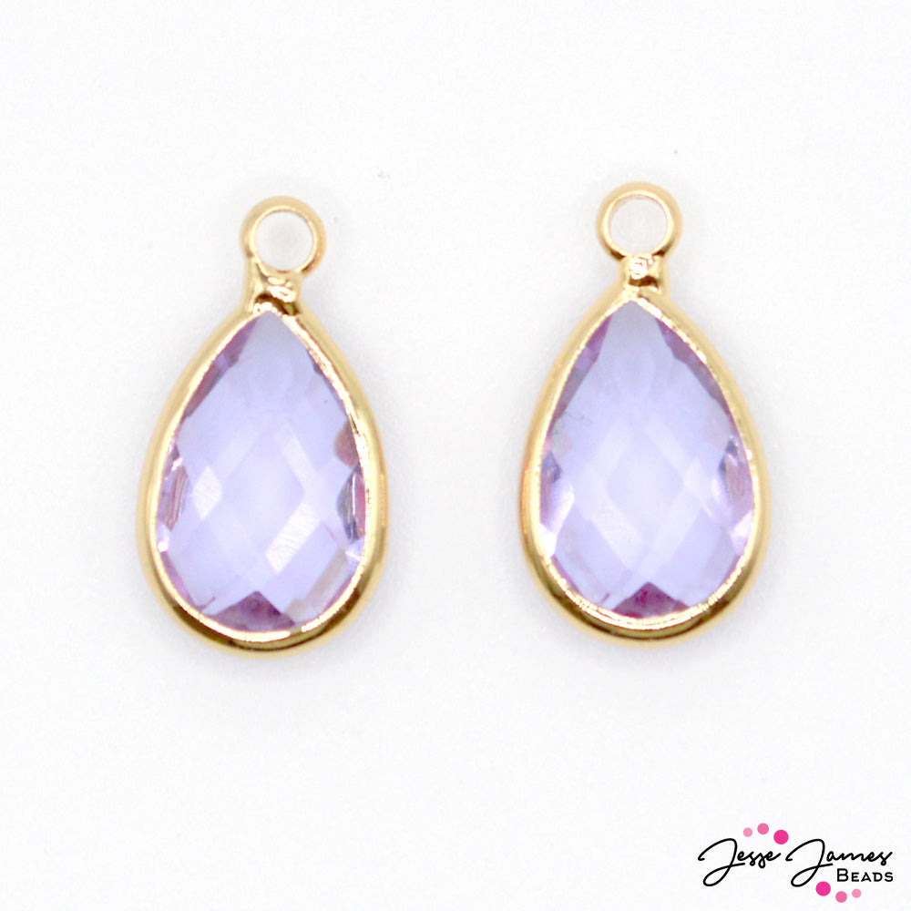 This charm set’s translucent lavender hue and the smooth tear-drop shape evoke the gentle allure of dew-kissed petals, while the subtle shimmer adds a touch of sparkle to any jewelry design. Charms measure 16mm X 9mm X 6mm. Each set contains 2 charms. 