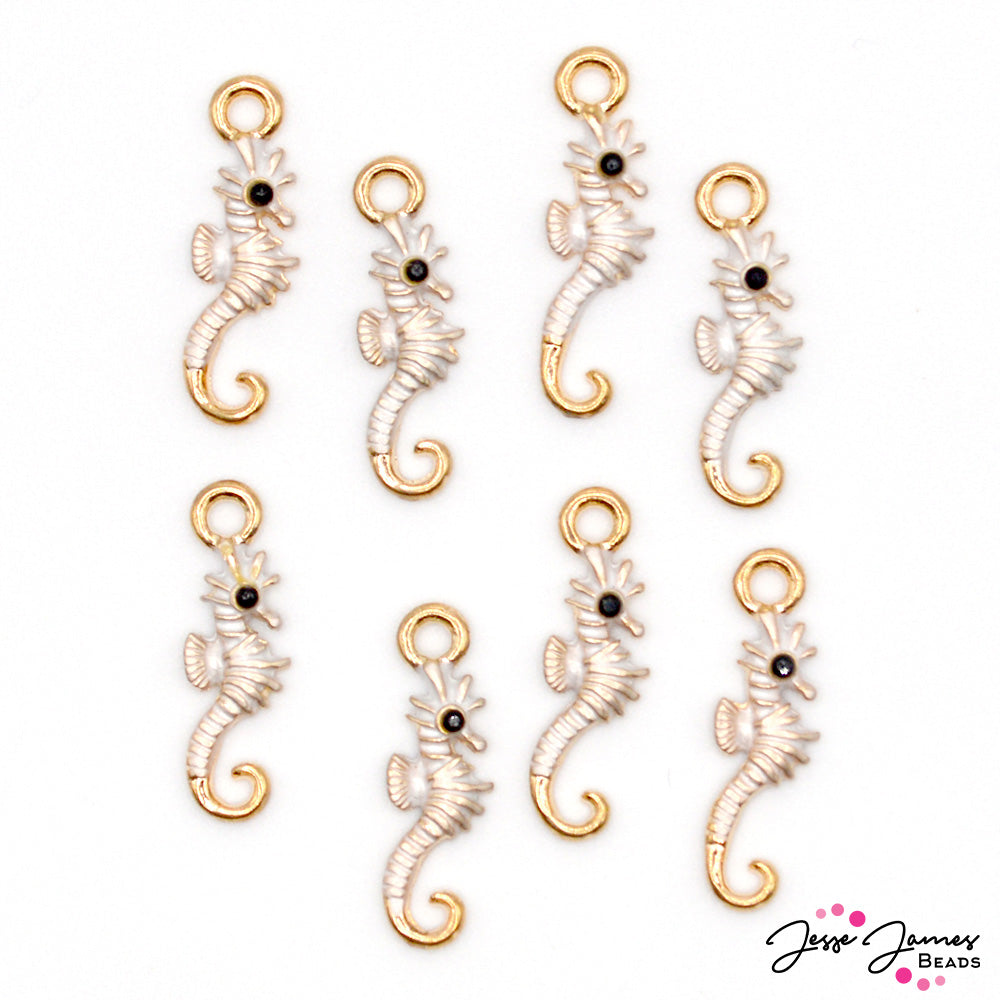 Each charm depicts a graceful seahorse in delicate detail.  The pristine white body and gold-dipped tail add a touch of elegance to any jewelry design. 8 charms per set. Charms measure 20mm X 6mm. 