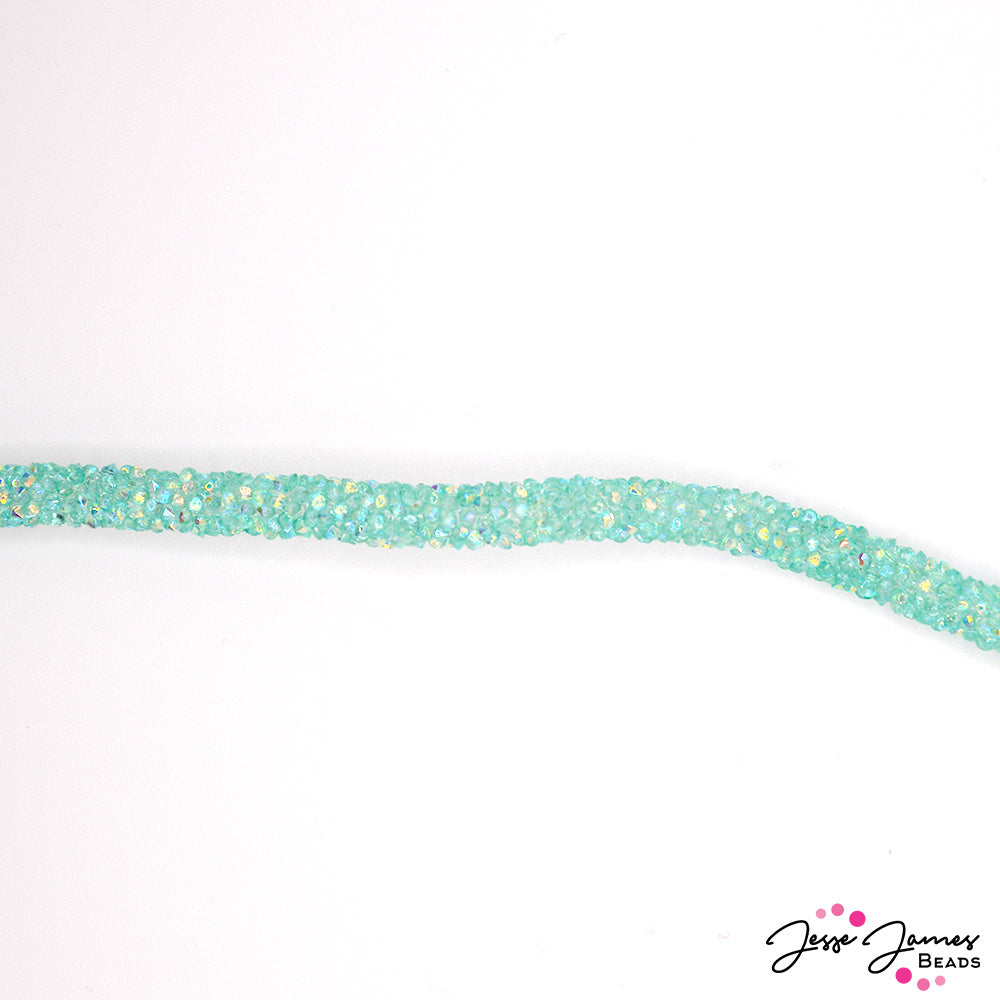 The subtle shimmer of the crystal-infused cord adds a touch of glamour to any project, catching the light and casting a gentle glow. Its jelly-like texture makes it fun to work with and perfect for unique bracelet designs.  Sold by the foot. Comes with 4 cord ends. Measure 6mm. 