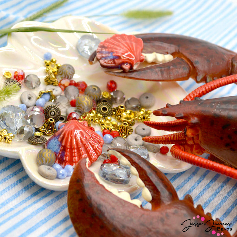 Ready to dive into juicy lobster? This bead mix is for you! Each mix features bold Lobster red beads paired with accents of crisp seaside blues and gold-plated metal accents. Largest bead in mix measures 24mm x 21mm. Smallest piece in mix measures 4mm x 2mm. This mini mix is stored in a reusable container for easy beading! 