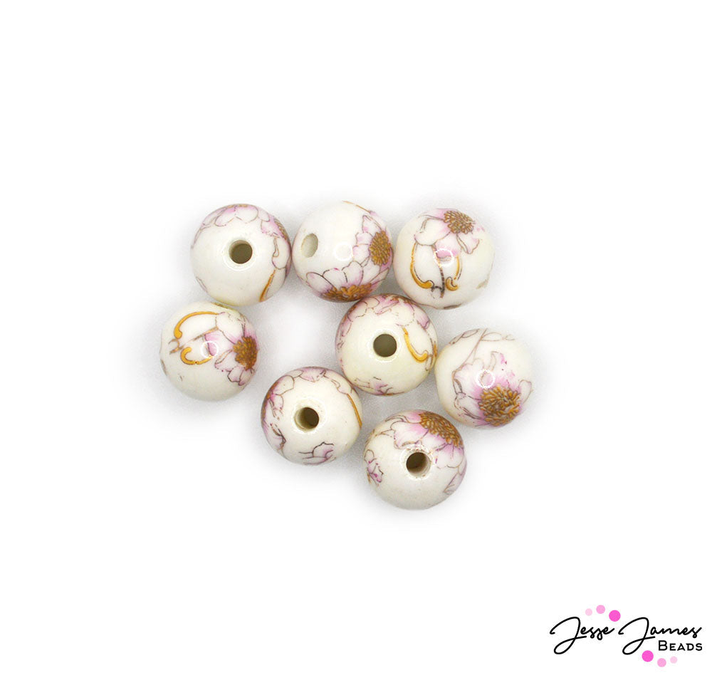 Add these adorable posies to your garden of beads. Each delicate flower bead features a detailed decal of floral delight on a creamy white base. These adorable little flowers make beautiful focal components for earrings, bracelets, and more. 8 beads per set. Measure 12mm.