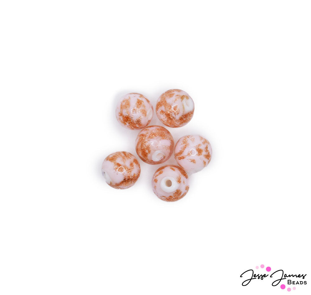 Enjoy the subtle flavor of a well-prepared berries & cream dessert with this darling collection of sparkling beads. Show a touch of whimsy at your next garden party event with these little beads swirled in creamy orange and pink glittered accents wrapped around a creamy white center. Each set includes 6 beads. Beads measure 10mm.