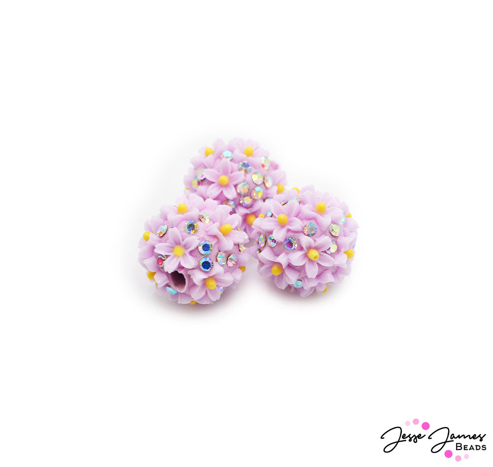 Ready to be this season's standout? One simply cannot have too much sparkle. These daisy-inspired beads feature a rich purple hue adorned with mini rhinestones for that must-have sparkle. 3 Beads per set. Measure 17mm.