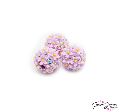 Ready to be this season's standout? One simply cannot have too much sparkle. These daisy-inspired beads feature a rich purple hue adorned with mini rhinestones for that must-have sparkle. 3 Beads per set. Measure 17mm.