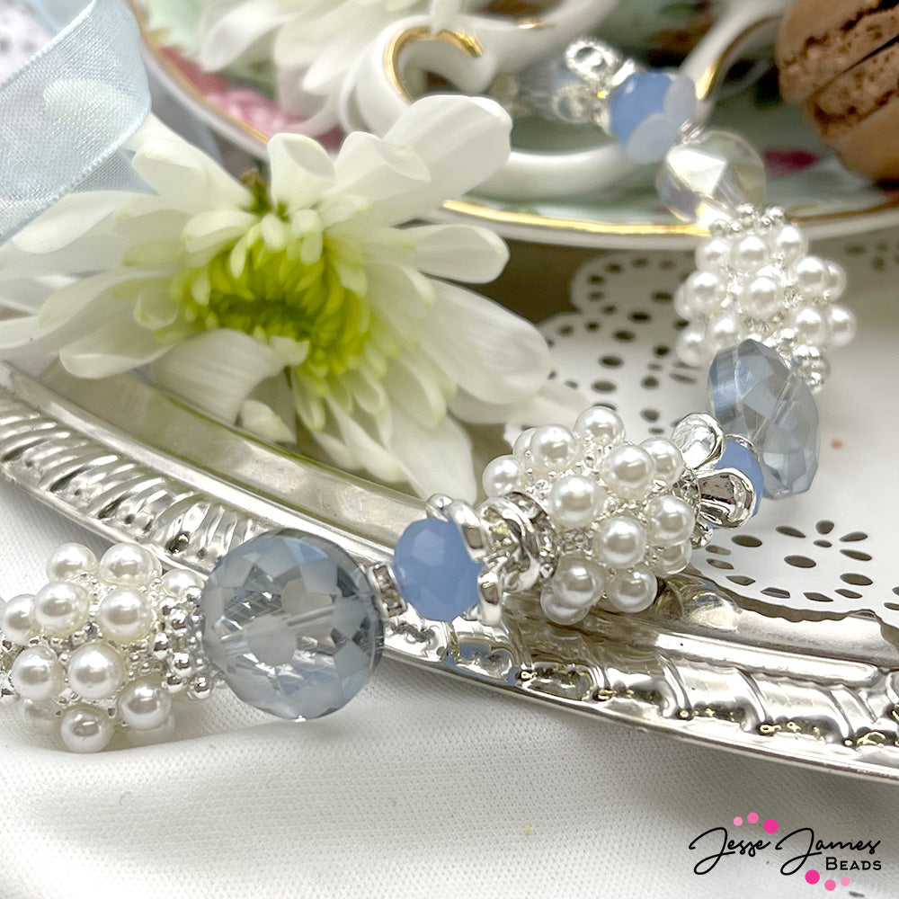 Take the world by storm with this daringly delicate duo of sparkling bead strands. Dazzle your designs with pearly white focal beads, sparkling silver-plated metals, and faceted glass in sky-blue hues. The largest bead in this set measures 17.5mm x 13.5mm. The smallest bead in this set measures 4mm x 2mm. Each strand is seven-inches in length.