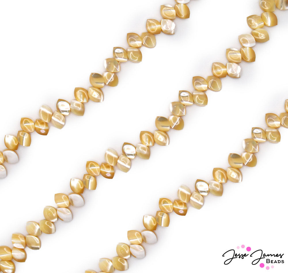 Enjoy a cup of the finest tea with these bright tan beads. this strand of same-style beads features a tea-leaf shape and a perfectly brewed amber-tan color.  Approx 60 beads per strand. Measure 9mm X 6mm X 3mm. 
