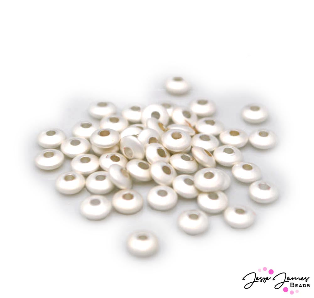 The perfect supporting character for any jewelry making creation. These beautiful brushed metal bead spacers feature a bright pearlized white hue to pair perfectly with bright hues and rich tones alike. Brass Spacer. Each bead measures 5.2mm x 1.5mm. 50 pieces per set