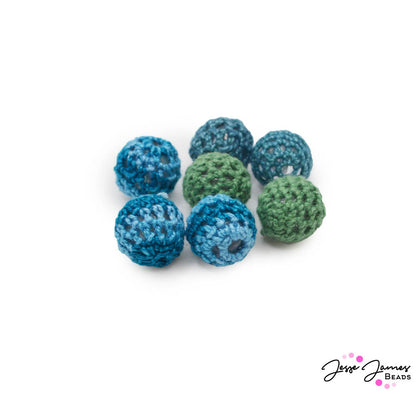 Add a pop of color to your jewelry creations with these yarn-wrapped beads dyed oceanic hues. This set includes dark blue, deep teal and green dyed beads. Beads measure 16mm. Each set includes 2 of each color bead.