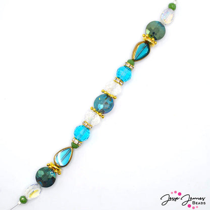 This 7 inch glass bead strand is filled with faceted glass beads in blue and teal hues. This strand includes gold-plated metal spacers and rhinestone spacers. Largest bead measures 17mm x 11.5mm x 5mm. Smallest bead measures 3mm x 5mm.