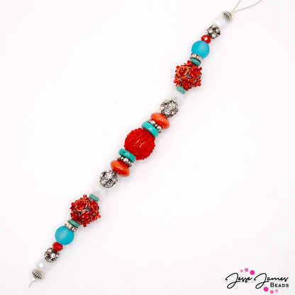 This daring 7 inch bead strand features a bold combo of scarlet red and teal. Each strand features metal rose beads, beaded focal beads, faceted glass, and more. Largest bead on strand measures 16mm. Smallest bead measures 6mm.