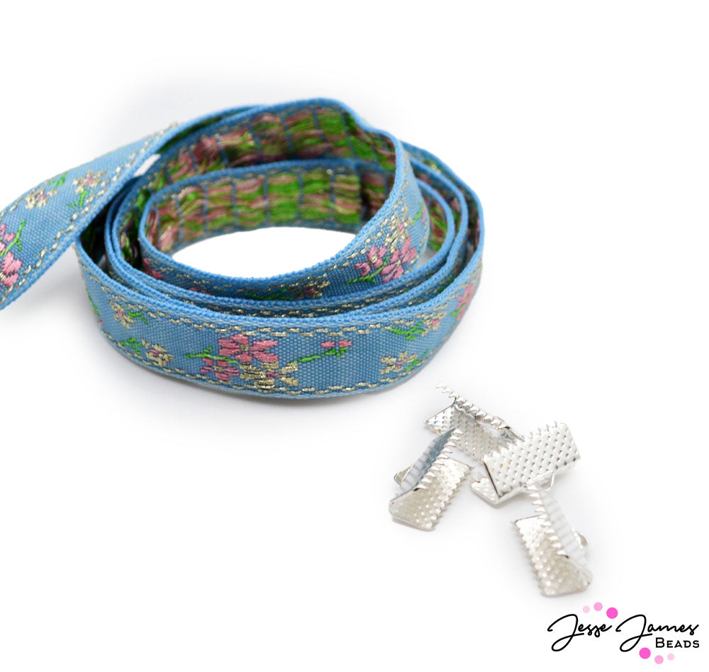 Searching for true love? This ribbon holds the key to a beautiful jewelry creation that you're sure to fall in love with. Embrace sky-blue hues embroidered with delicate flowers and floral accents. Ribbon sold in 1 Yard Cuts. 4 Clasps per order.