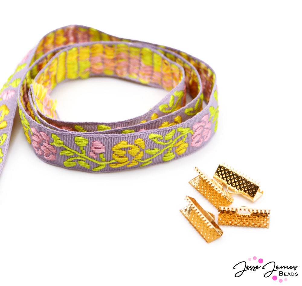 Don't be caught without this beautiful ribbon! Join a garden party of color with a beautiful purple ribbon embroidered with bright pink and yellow flowers. Each ribbon is sold in 1-yard increments, perfect for creating stunning necklaces, earrings, and more. Don't fret dear, your ribbon also comes with 4 clasps to help you finish your project with an elegant flourish.