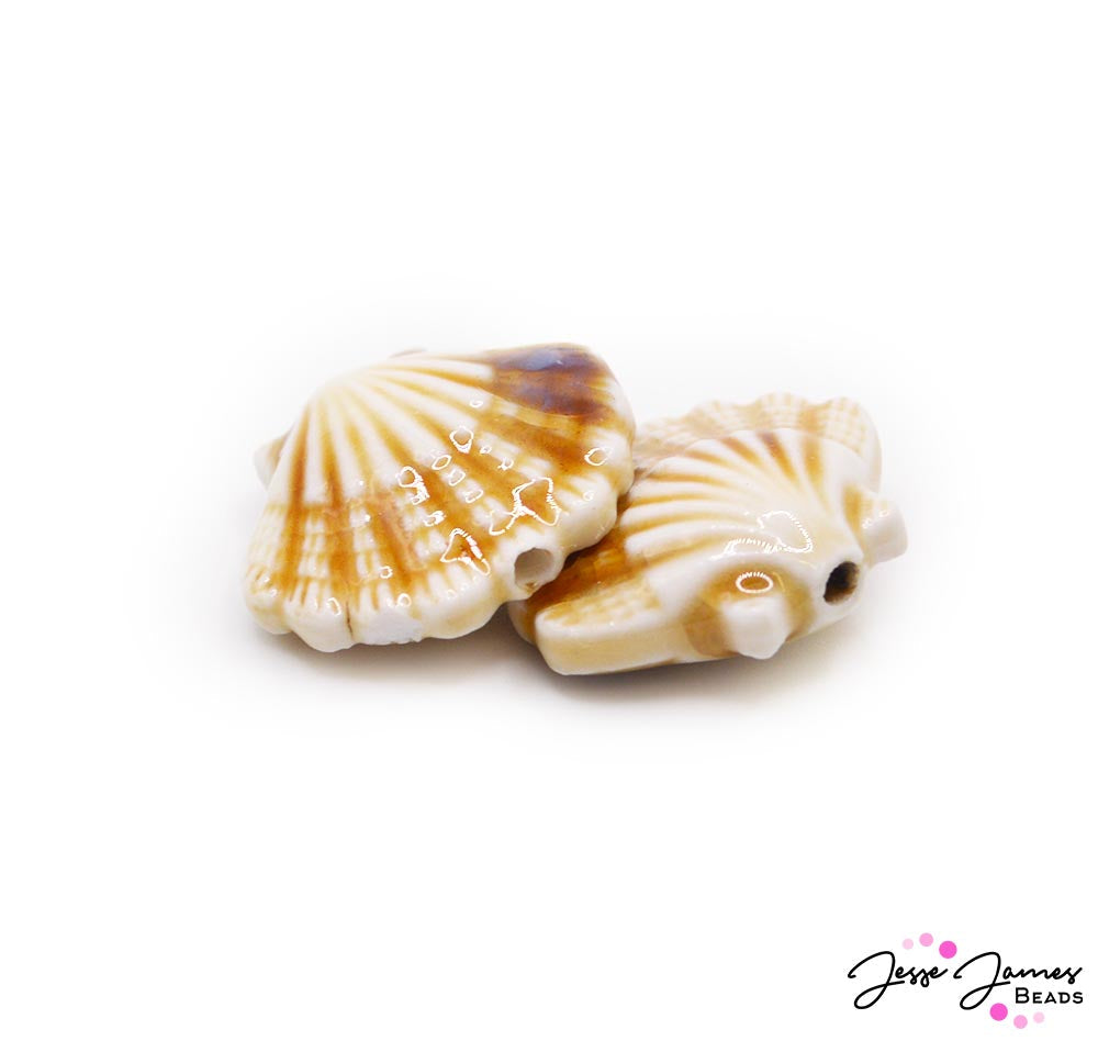 Create your own sand dune dreams with these creamy sand colored ceramic seashell beads. Each bead measures 20.5 x 22mm. Sold in pairs.