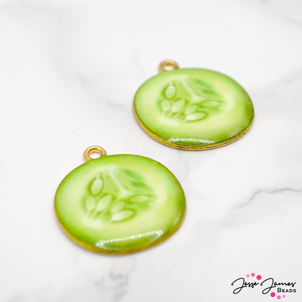 Embrace the rejuvenating vibes of a spa day with our Spa Cucumber Slice Charm Pair. Add a splash of freshness to your jewelry creations and let these charming cucumber slices inspire you to craft pieces that are both beautiful and revitalizing. Charms measure 23mm. 2 charms per order. 