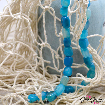 These rich blue jasper beads feature an oceanic teal hue. Each bead measures 10mm x 14.5mm. Sold in sets of 26. Please note beads may or may not arrive on a strand due to the weight of these stones. Great for necklaces, bracelets, and more!