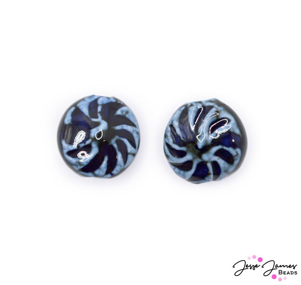 These ceramic beads feature a rich dark blue marbling of color! These beads make a perfect focal piece for necklaces, bracelets, and more. Sold in pairs. Each bead measures 20mm.