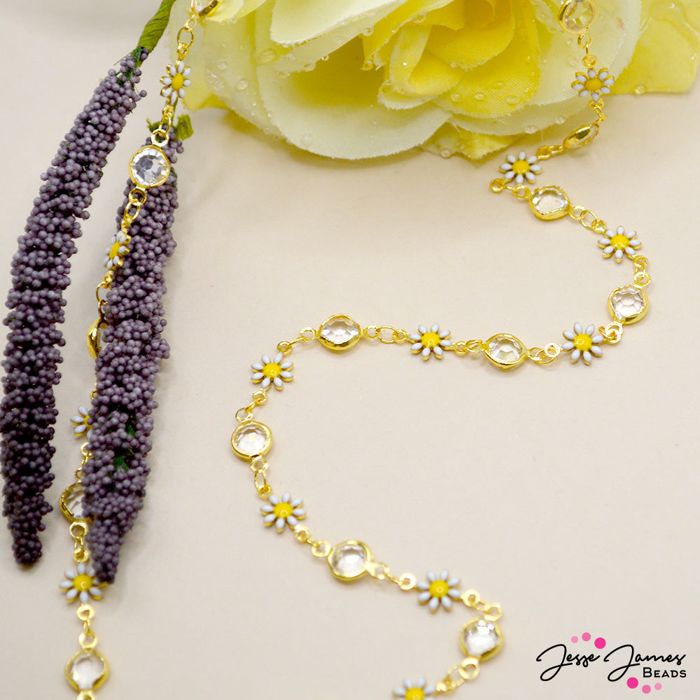 This sparkling rhinestone chain features handmade brass links adorned with enamel and sparkling rhinestones. Each flower link measures 12mm x 7mm x 2mm. Rhinestone links measure 6.6mm x 12mm x 3mm. Chain is sold in 1 meter increments