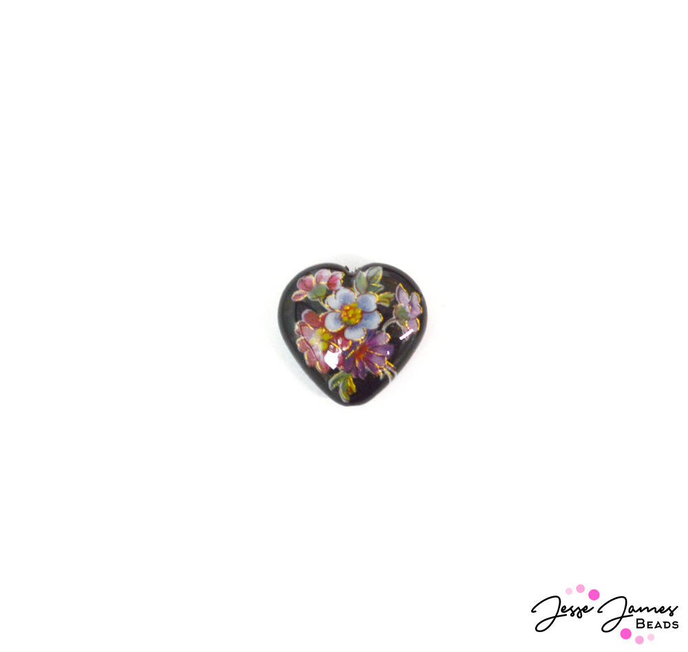 This Tensha bead features a rich dark black background overlaid with a colorful pop of wildflowers. Each bead is crafted by hand using a delicate decal set gently on an acrylic heart. Each bead is then fully lacquered with another acrylic coating to protect the beads from scratching and abrasion. These heart beads measure bead measures 22.6mm x 24mm x 8.5mm.