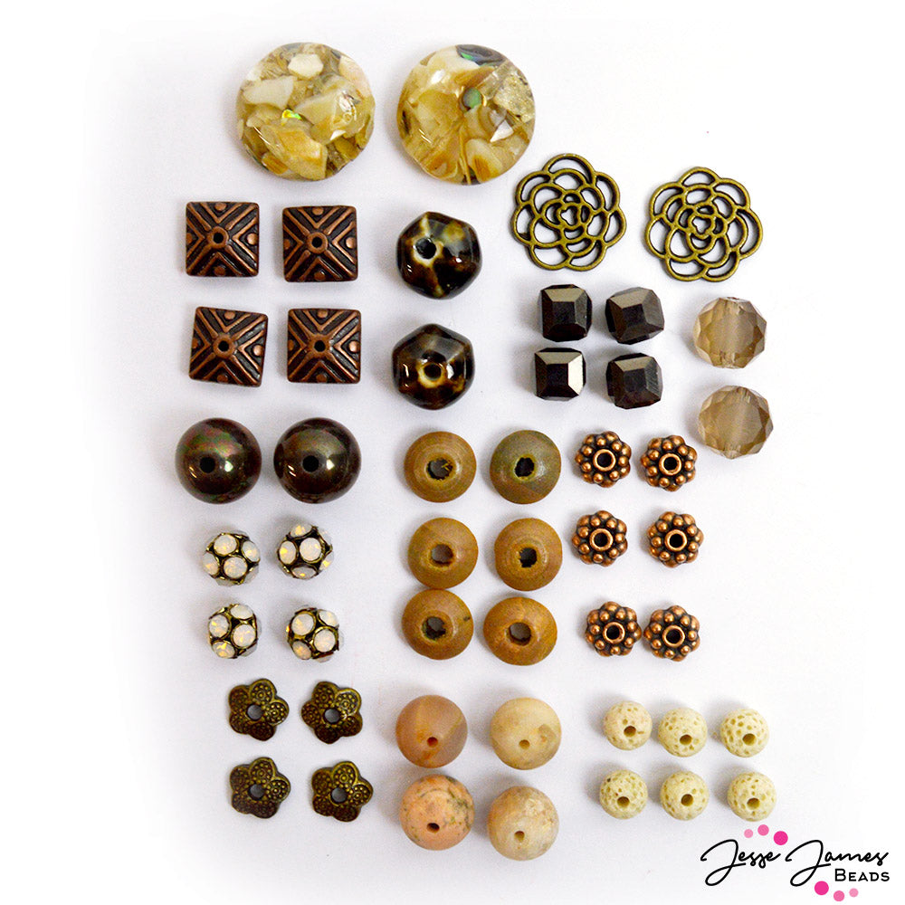Stone Age Bead mix from Jesse James Beads Features ceramic beads, faceted glass, metal charms, metal bead caps, metal spacers, and more.