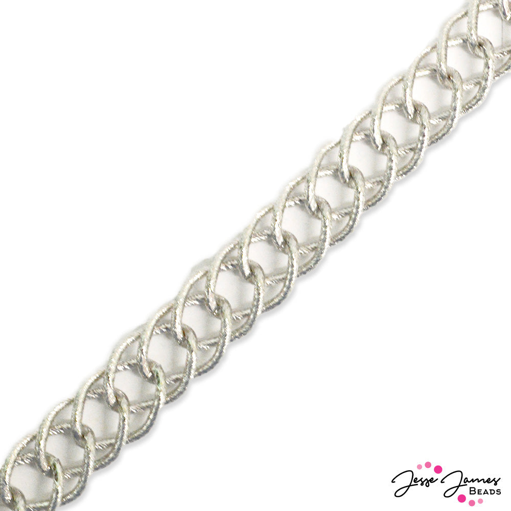 Make waves with this bold statement chain! The motion of the ocean is strong with the Waves Loop Chain from JJB. Textured chain links in a thick and chonky chain style pairs great with larger JJB strands and bead mixes. Make statement jewelry with large chain. Rhodium plated. Sold in 1 meter lengths. Links measure 20mm x 12mm x 2mm.