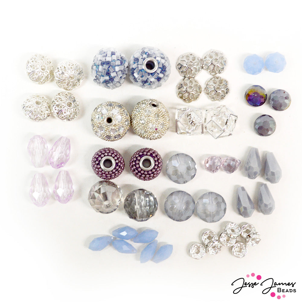 Embrace the cold Winter nights with the Celtic Goddess of Winter herself. This chilling bead mix is inspired by the Queen of Winter, featuring cool hues of purple, blue, and silver metals. Each bead mix contains encrusted boho beads, large hole boho beads, faceted glass, silver caged crystal beads, silver rhinestone spacers, and more. Largest bead in mix measures 18mm x 15m. Smallest bead in mix measures 8mm x 3mm.
