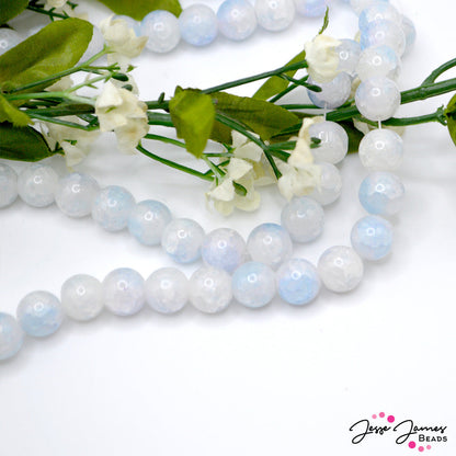 Sunny with a chance of periwinkle clouds! These white and purple swirl beads are the perfect compliment to any Spring design. Add to earrings, necklaces, or bracelet project. Approx. 80 beads per strand. Due to the nature of these beads, color may vary in each bead. Measure 10mm. 